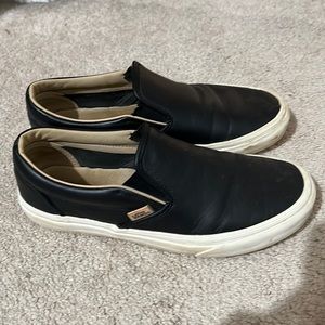 Black leather Vans slip ons